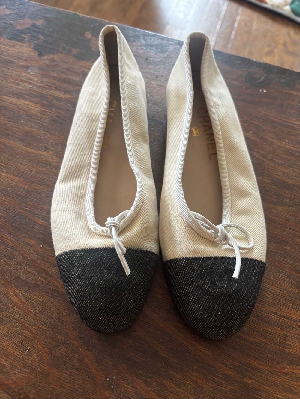 CHANEL Ivory Canvas Ballet Flats with Black Cap Toe and Bow